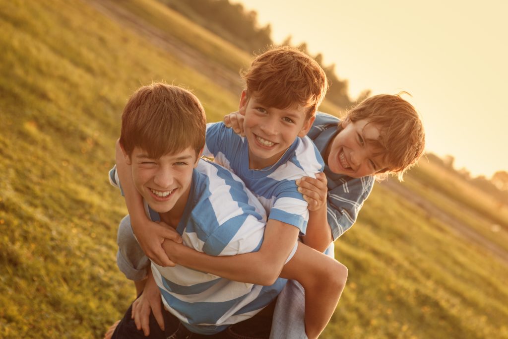 Portrait of three happy cheerful brothers